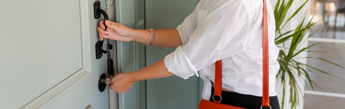 a person locking the front door of a vacation rental